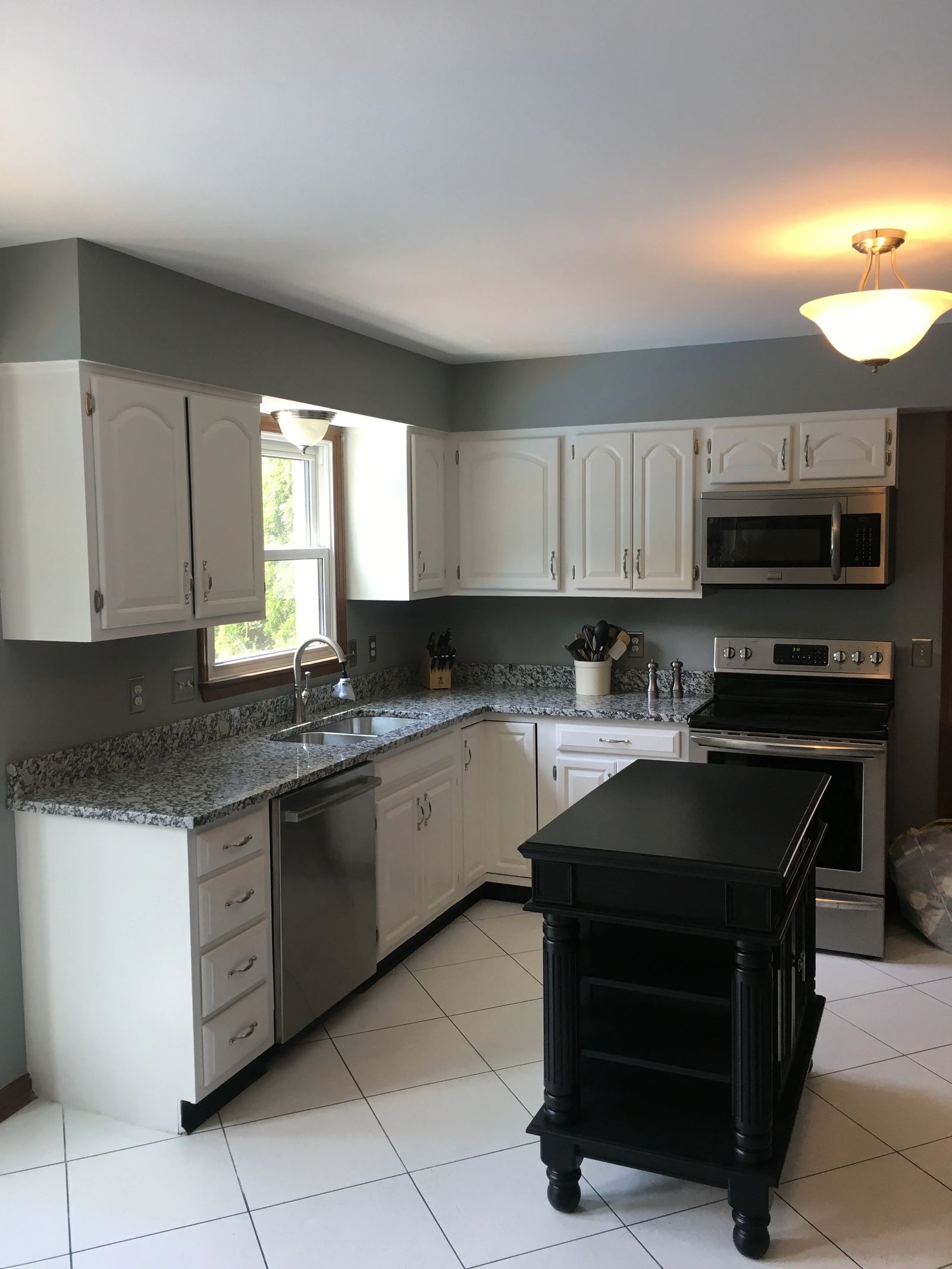 White kitchen cabinets after refinishing in West Chester, from Andrews Painting Company’s published gallery.