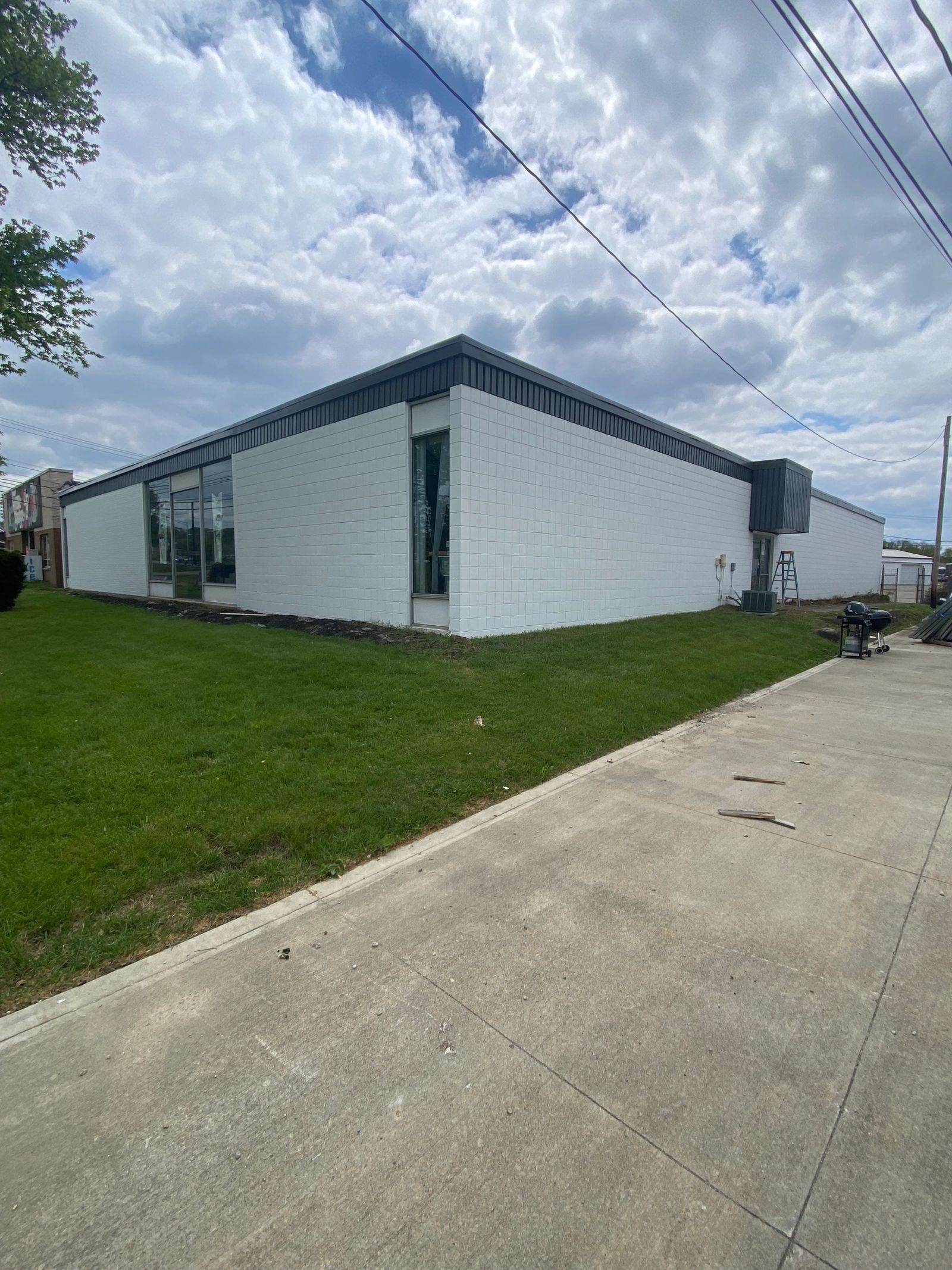 A finished white and charcoal commercial building from Andrews Painting Company’s project gallery.